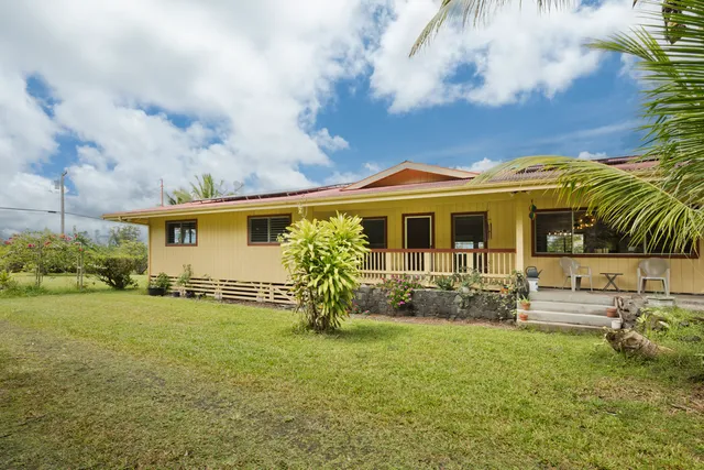 a view of a house with a yard patio and sitting area