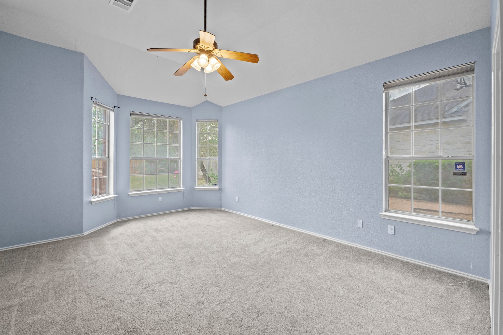 8605 Axis Drive Austin, TX 78749 - Photo 17 of 38 A spacious bedroom features multiple windows for abundant natural light, complemented by a convenient ceiling fan.