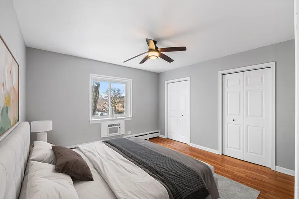 a bedroom with a large bed and a chandelier