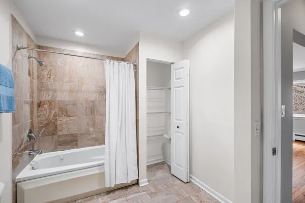 a bathroom with a shower and a tub
