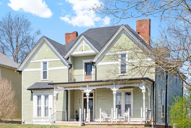 a view of a brick house with large windows