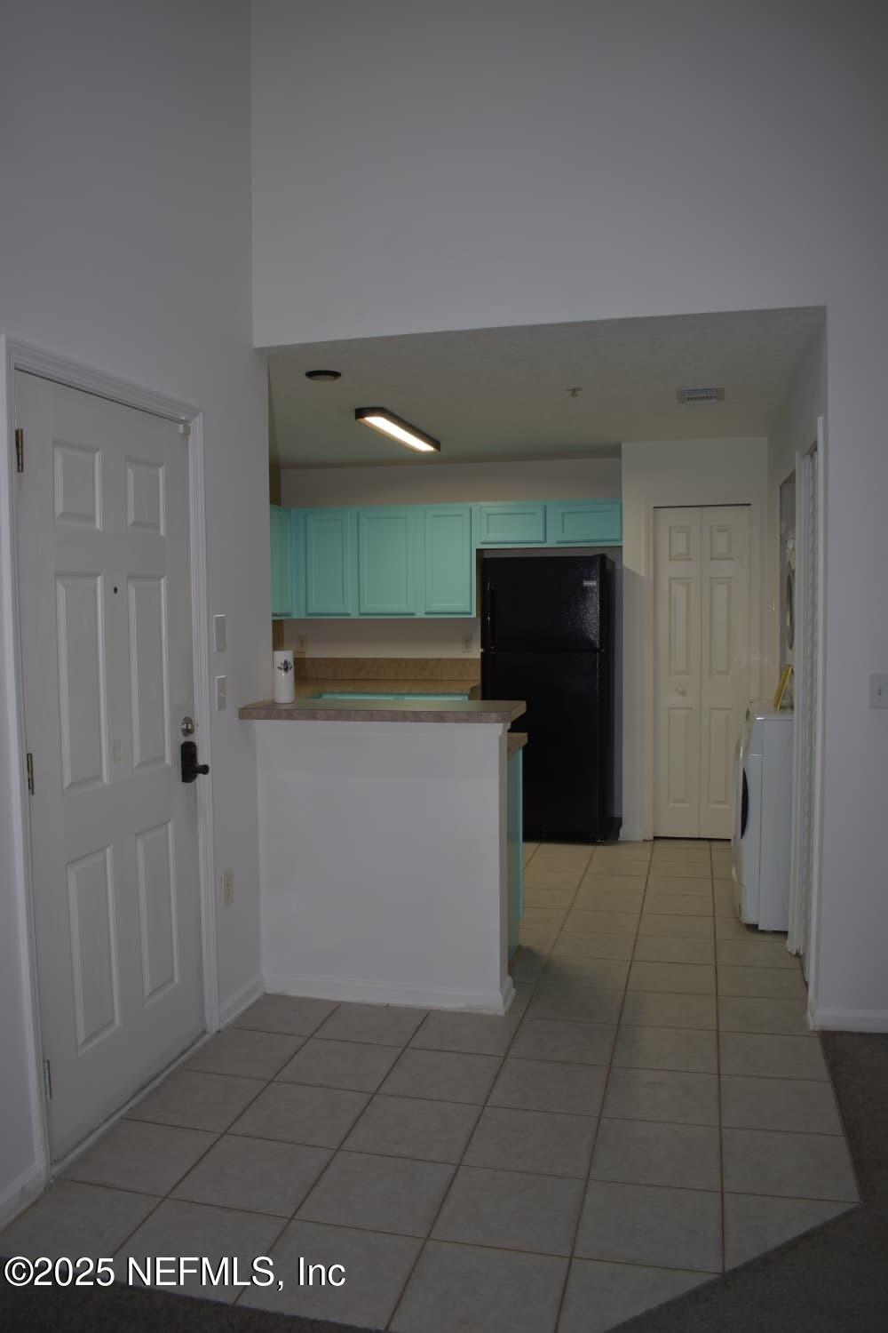 7920 Merrill Road, Unit 1710 Jacksonville, FL 32277 - Photo 11 of 51 a view of kitchen with refrigerator and window