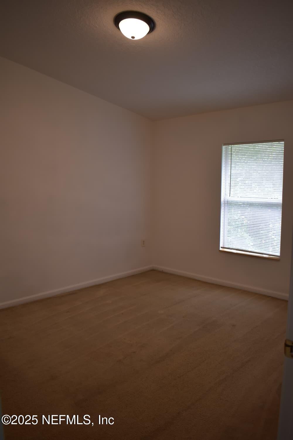 7920 Merrill Road, Unit 1710 Jacksonville, FL 32277 - Photo 18 of 51 an empty room with a window