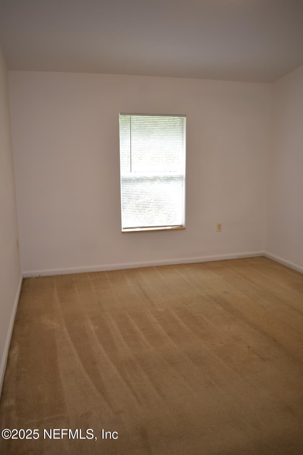 7920 Merrill Road, Unit 1710 Jacksonville, FL 32277 - Photo 25 of 51 an empty room with a window