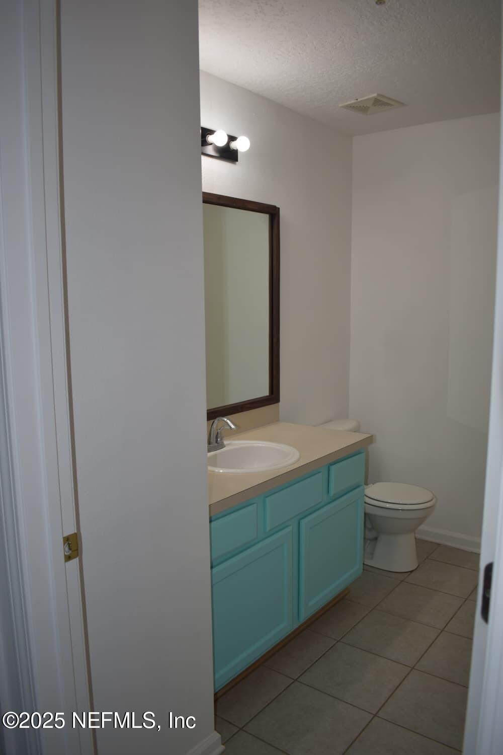 7920 Merrill Road, Unit 1710 Jacksonville, FL 32277 - Photo 27 of 51 a bathroom with a toilet sink and mirror