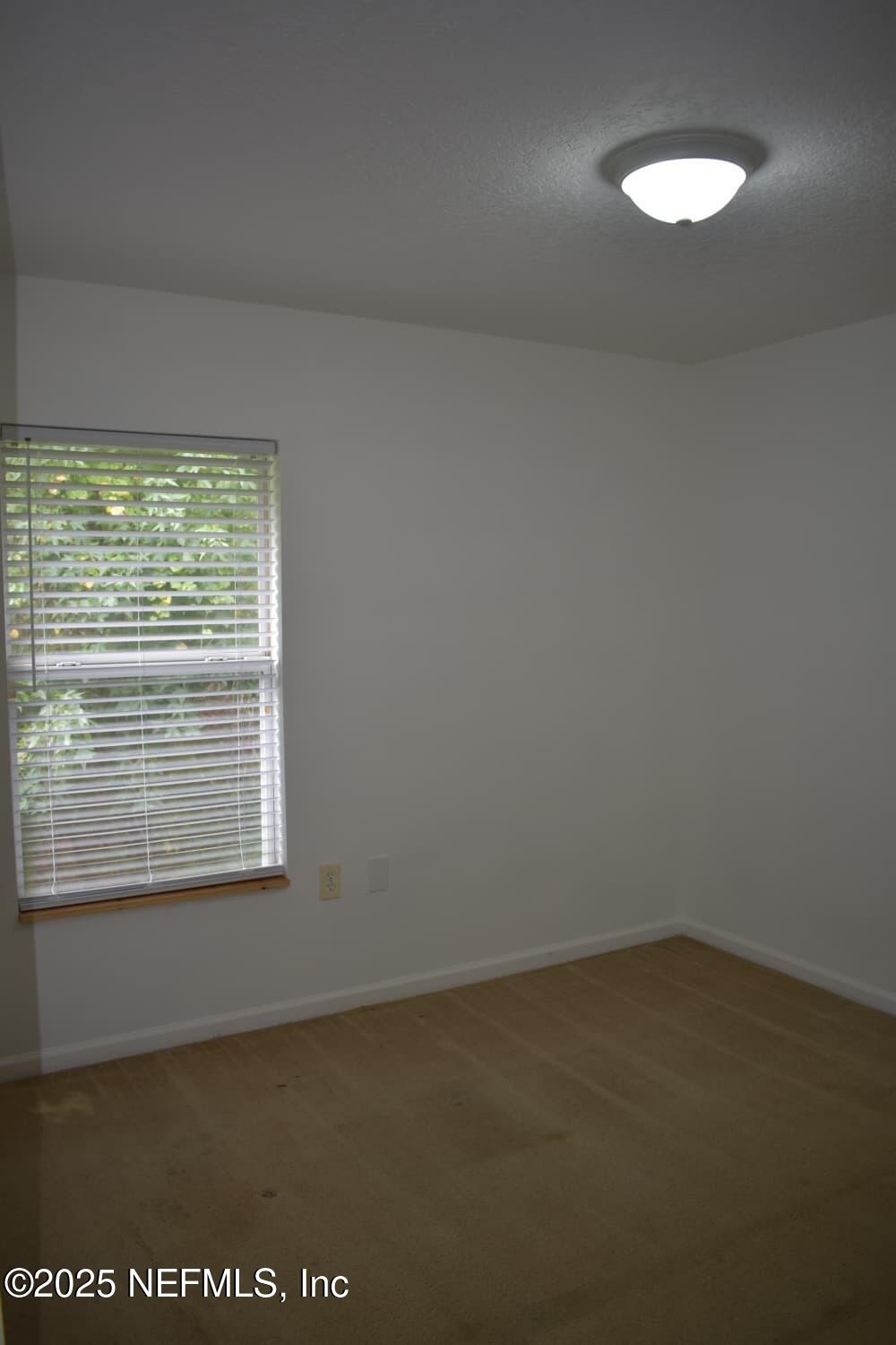 7920 Merrill Road, Unit 1710 Jacksonville, FL 32277 - Photo 31 of 51 a view of an empty room with a window