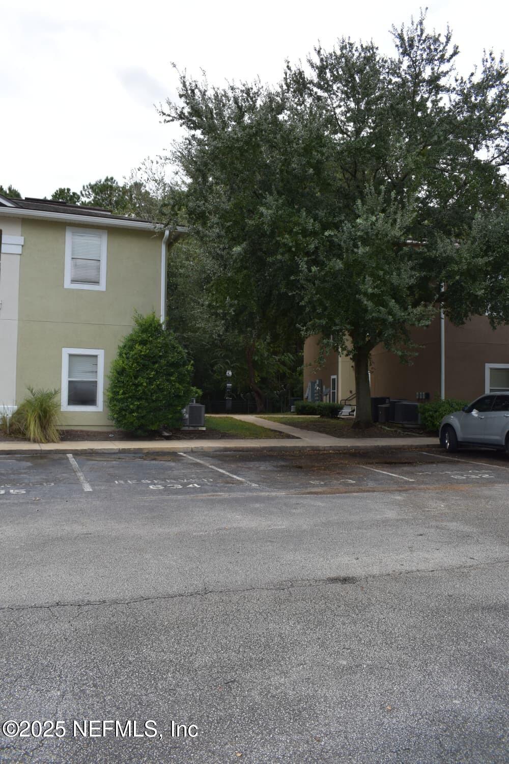 7920 Merrill Road, Unit 1710 Jacksonville, FL 32277 - Photo 44 of 51 a view of a house with a yard