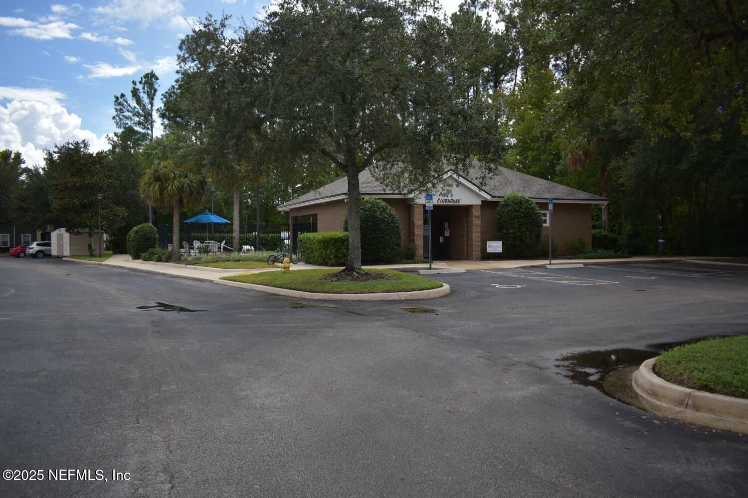 7920 Merrill Road, Unit 1710 Jacksonville, FL 32277 - Photo 45 of 51 a front view of a house with a yard and garage