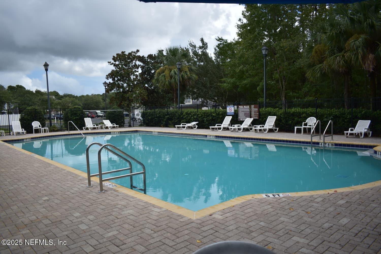7920 Merrill Road, Unit 1710 Jacksonville, FL 32277 - Photo 47 of 51 a view of a lake with chairs