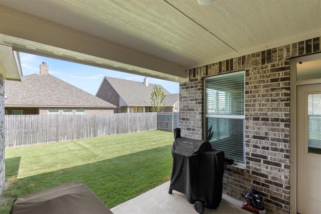 3306 Greymoore Drive Anna, TX 75409 - Photo 24 of 32 Covered patio area ideal for grilling, relaxing, or setting up outdoor furniture.