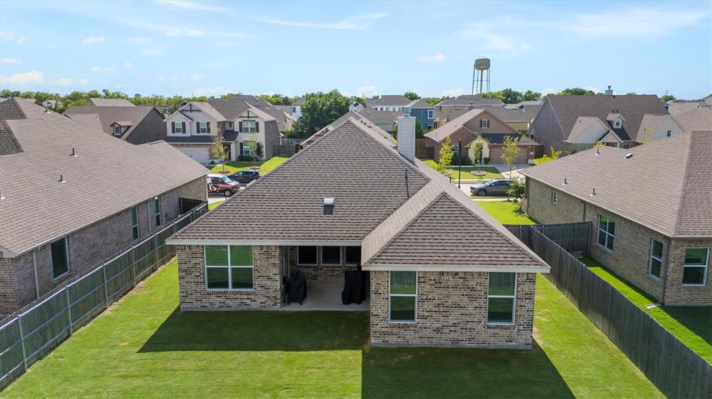 3306 Greymoore Drive Anna, TX 75409 - Photo 25 of 32 Spacious backyard with covered patio—ready for outdoor living and entertaining