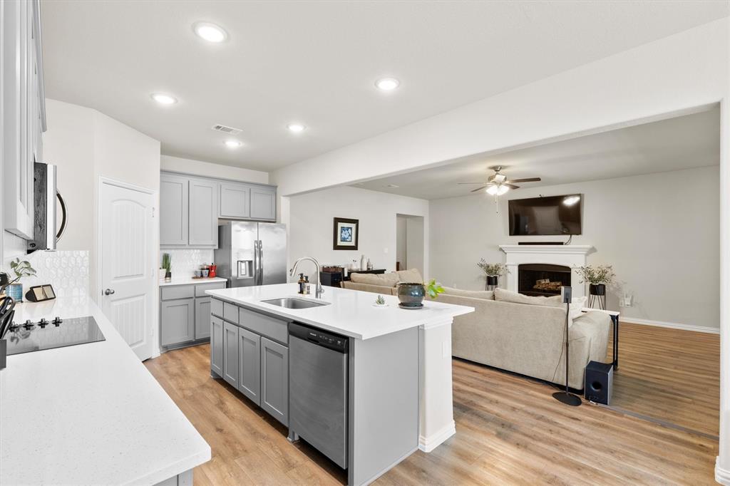 3306 Greymoore Drive Anna, TX 75409 - Photo 6 of 32 Clean, move-in ready kitchen with ample cabinet space and a view into the main living area.