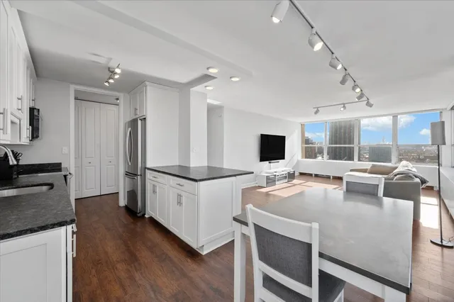 a kitchen with sink cabinets and stainless steel appliances