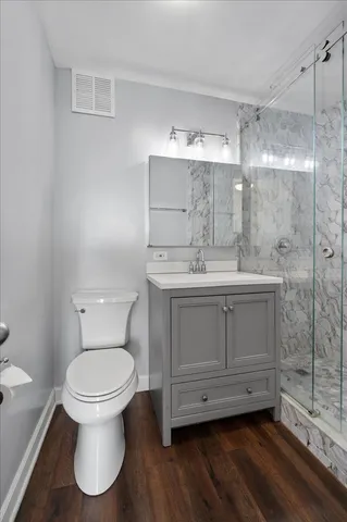 a bathroom with a sink toilet and shower
