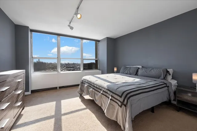 a bedroom with a bed lamp and window