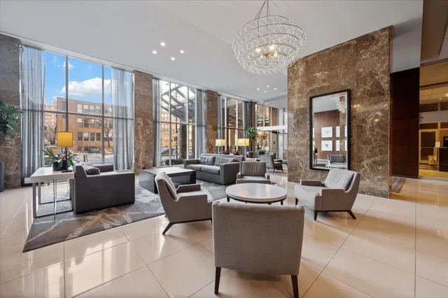 a living room with furniture and a chandelier