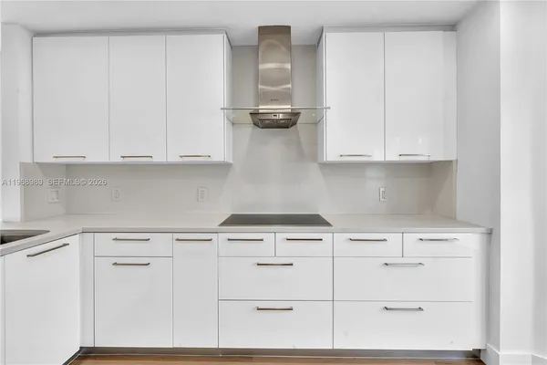 a kitchen with white cabinets and a stove with white stainless steel appliances