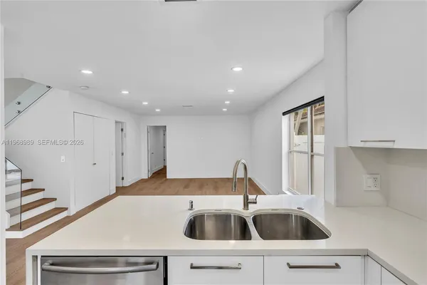 a kitchen that has a sink and a microwave