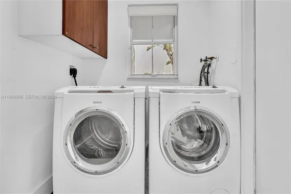 a view of a hallway with washer and dryer