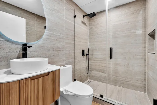a bathroom with a toilet sink and shower