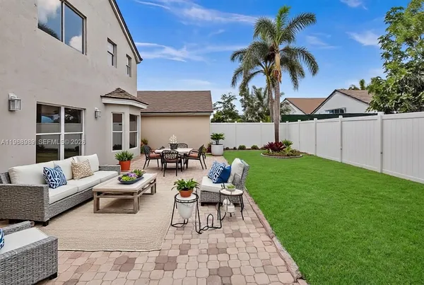 a view of a patio with couches and a fire pit