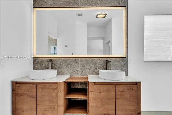 a bathroom with a sink and a mirror
