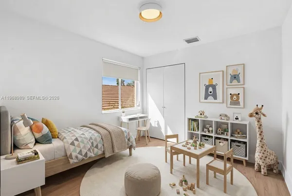 a bedroom with furniture and a wooden floor