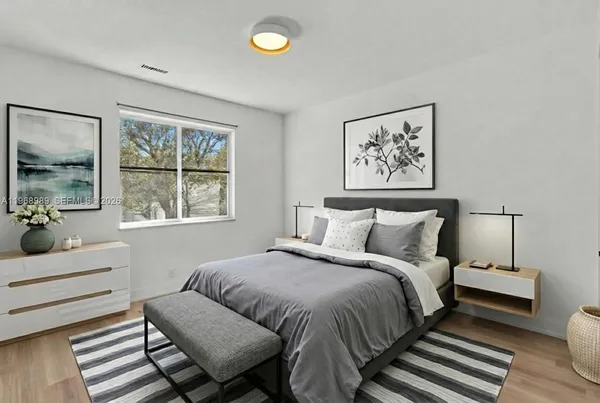 a bedroom with a bed and wooden floor