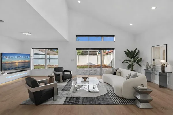 a living room with furniture window and flat screen tv