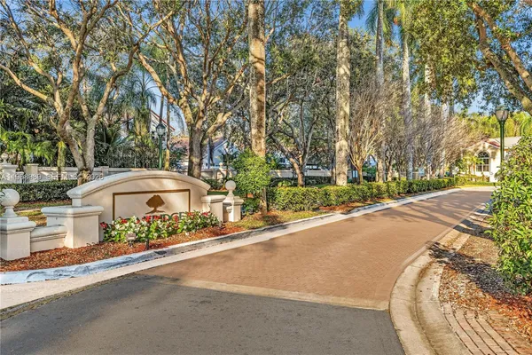 a front view of a house with a garden and trees