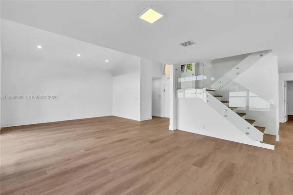 a view of entryway and hall with wooden floor