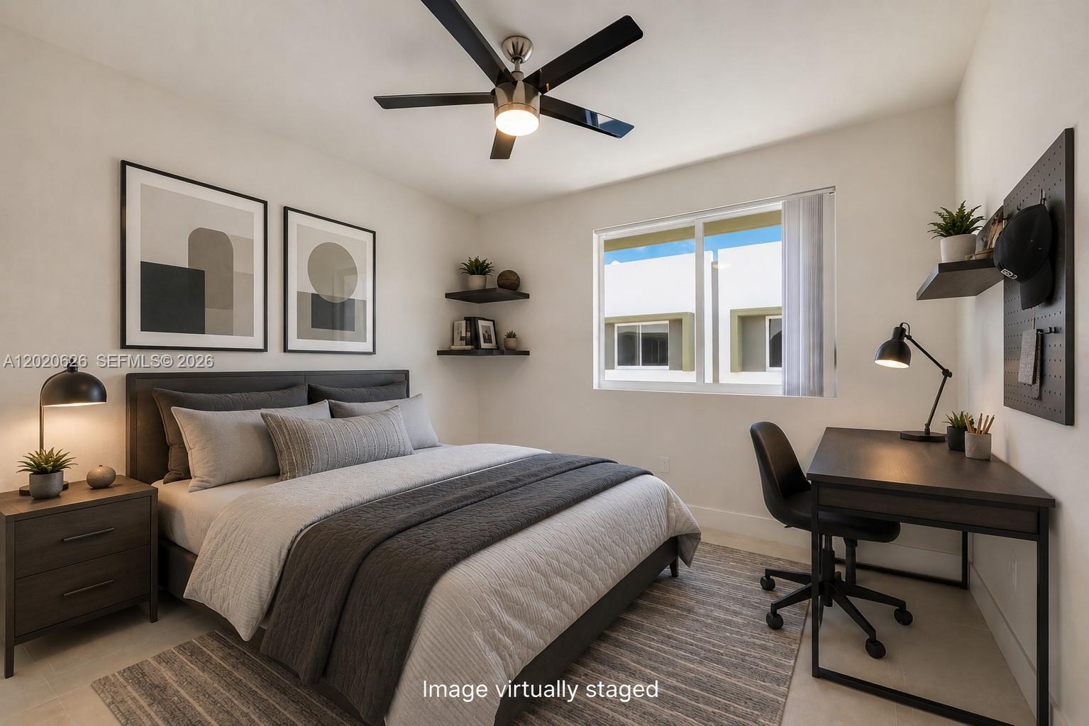 7701 Southwest 95th Terrace, Unit 1 Miami, FL 33156 - Photo 6 of 18 a bedroom with a bed a desk and chair with a large mirror next to a window