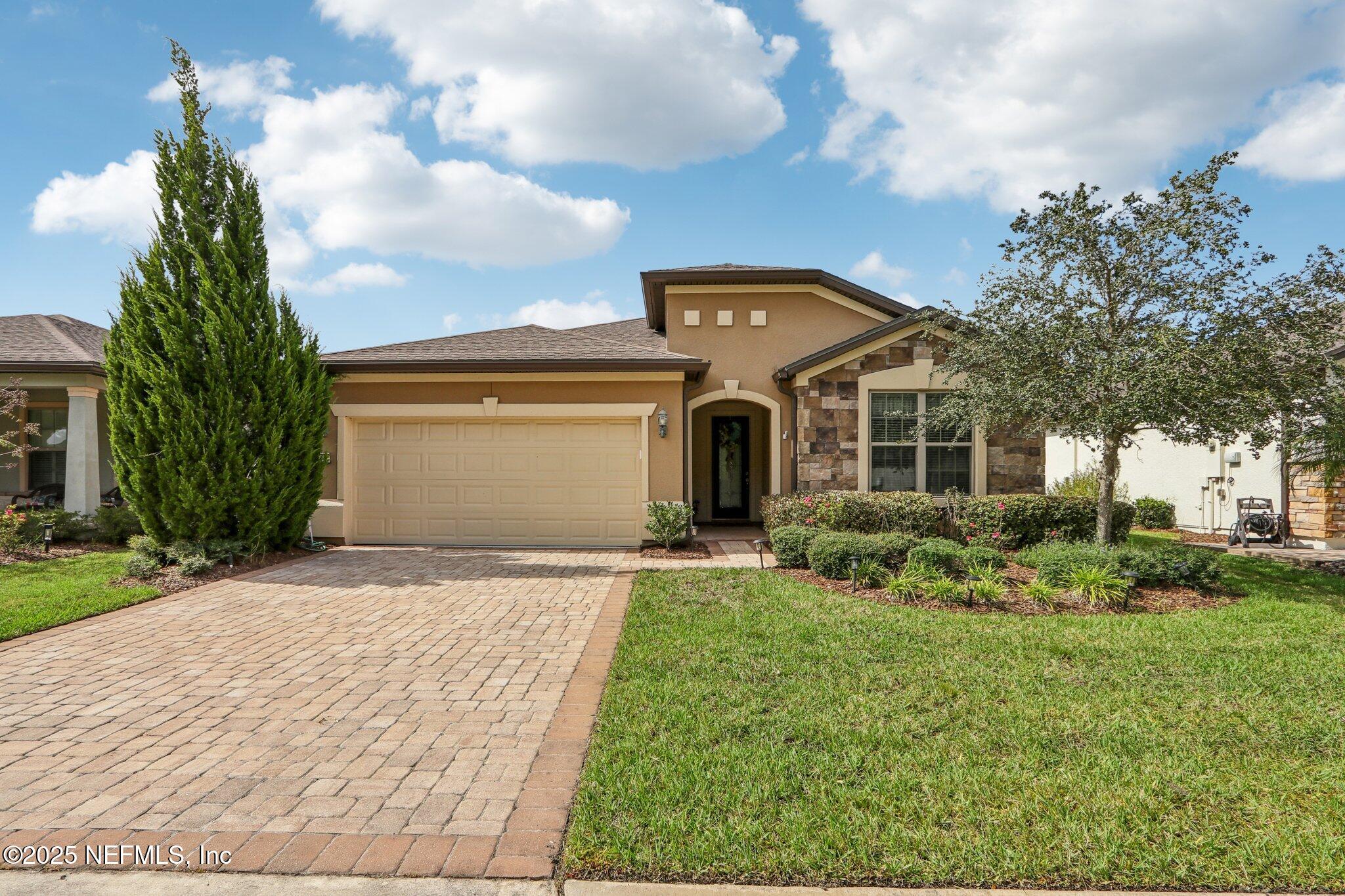 a front view of a house with a yard and garage