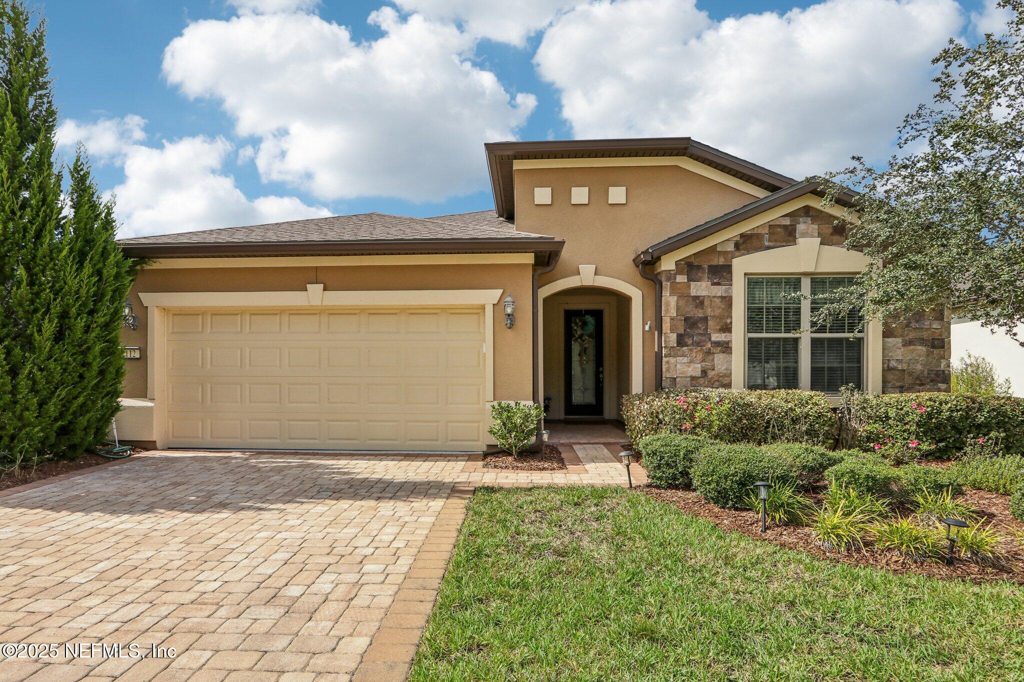 112 Bridge Oak Lane St. Augustine, FL 32095 - Photo 2 of 47 a front view of a house with a yard