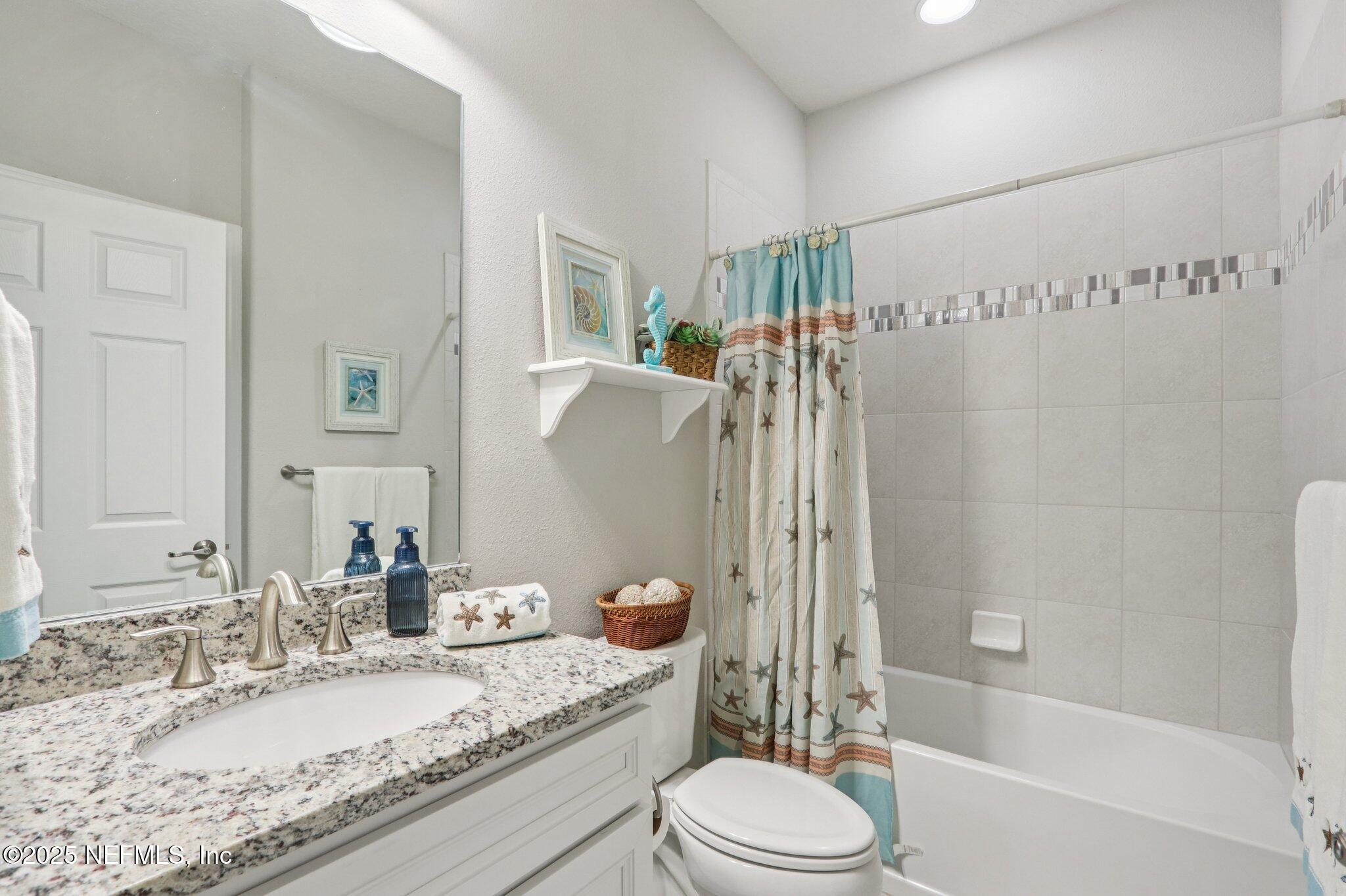 112 Bridge Oak Lane St. Augustine, FL 32095 - Photo 21 of 47 a bathroom with a granite countertop sink a toilet and shower