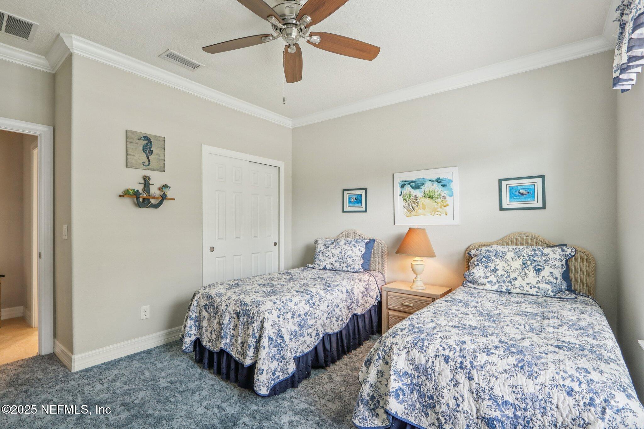 112 Bridge Oak Lane St. Augustine, FL 32095 - Photo 23 of 47 a bedroom with two beds and a chandelier
