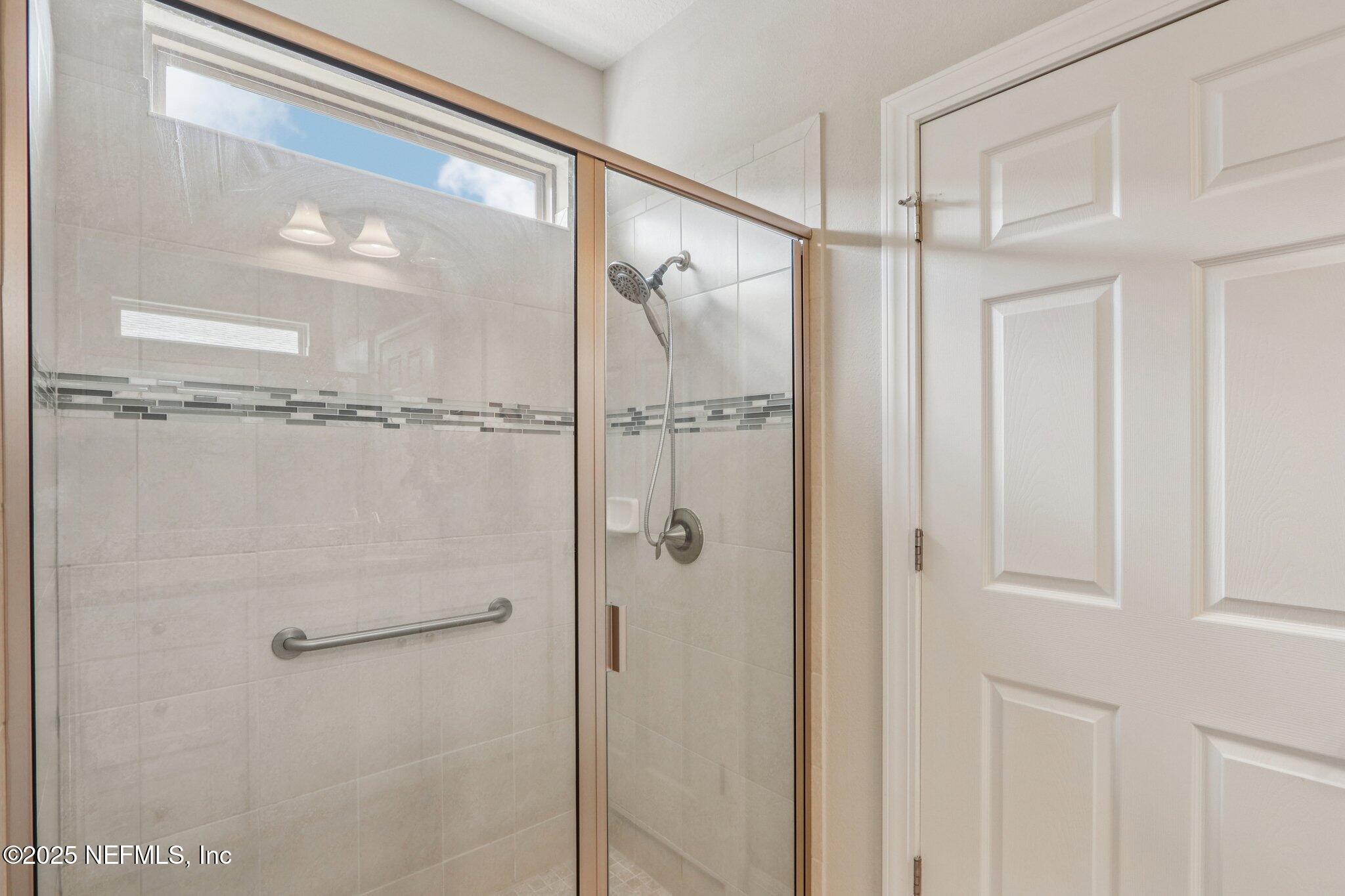 112 Bridge Oak Lane St. Augustine, FL 32095 - Photo 33 of 47 a bathroom with a glass shower door