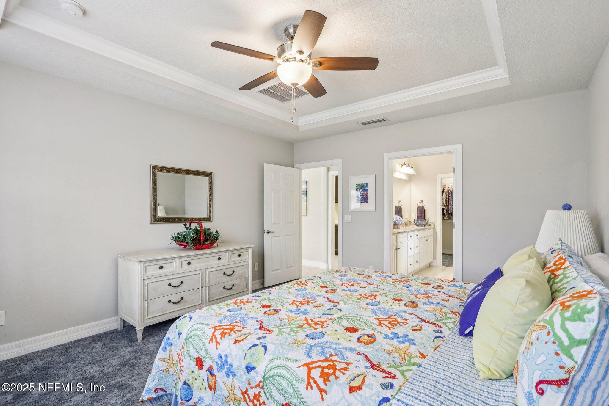 112 Bridge Oak Lane St. Augustine, FL 32095 - Photo 36 of 47 a bedroom with a bed and a chandelier