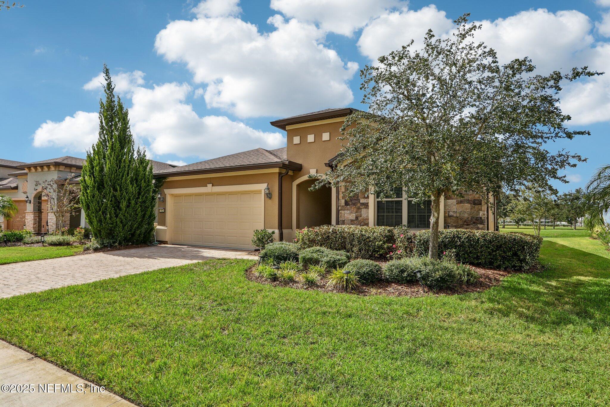 112 Bridge Oak Lane St. Augustine, FL 32095 - Photo 4 of 47 a front view of a house with garden