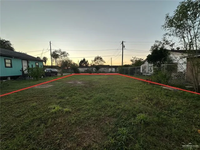 a view of a field of grass and trees