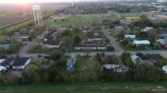an aerial view of lake and residential houses with outdoor space