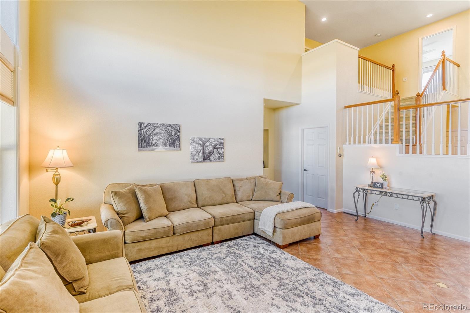 3897 Mallard Lane Highlands Ranch, CO 80126 - Photo 12 of 50 a living room with furniture and a lamp