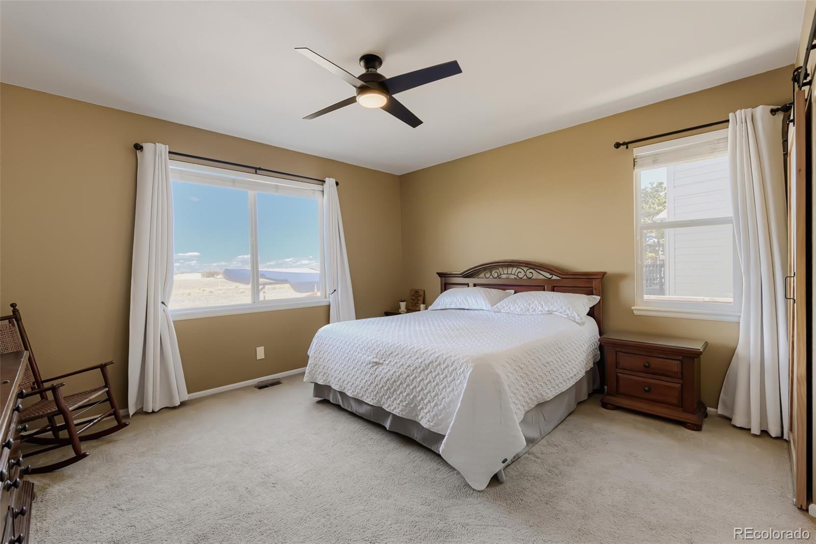 3897 Mallard Lane Highlands Ranch, CO 80126 - Photo 14 of 50 a bedroom with a bed and a window