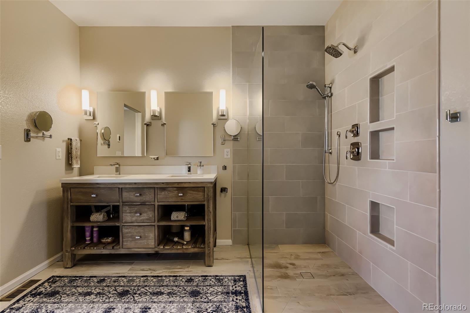 3897 Mallard Lane Highlands Ranch, CO 80126 - Photo 17 of 50 a bathroom with a double vanity sink a mirror and a shower