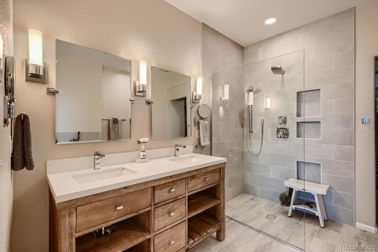 3897 Mallard Lane Highlands Ranch, CO 80126 - Photo 18 of 50 a bathroom with a double vanity sink mirror and shower