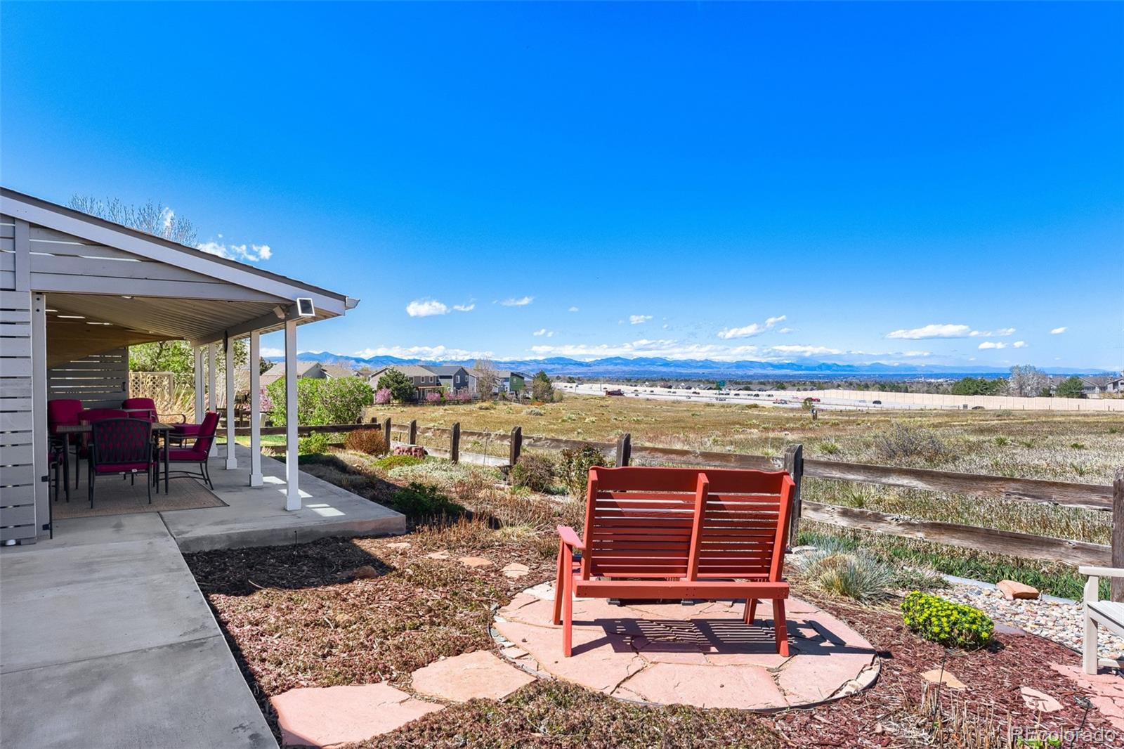 3897 Mallard Lane Highlands Ranch, CO 80126 - Photo 33 of 50 a view of a patio with a table and chairs under an umbrella