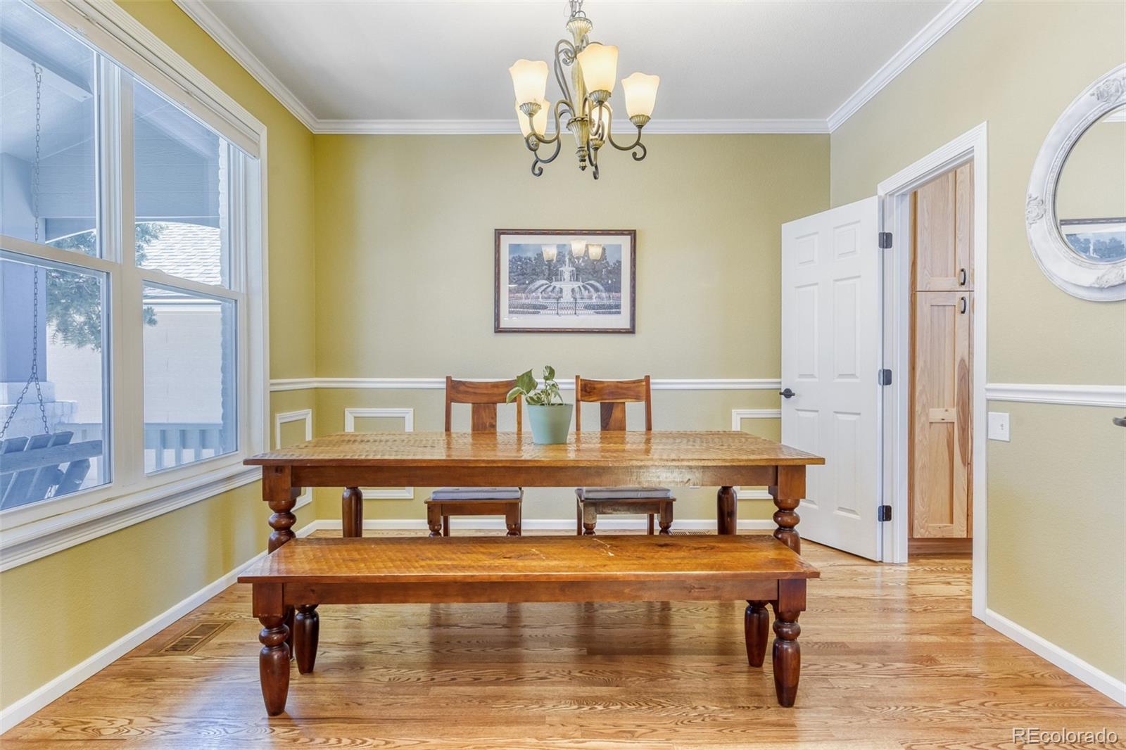 3897 Mallard Lane Highlands Ranch, CO 80126 - Photo 4 of 50 a view of a dining room with furniture a chandelier and wooden floor
