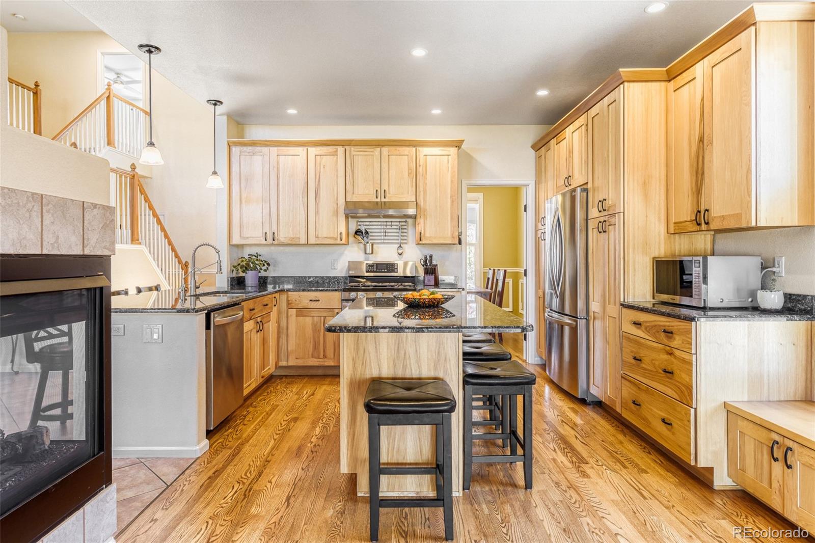 3897 Mallard Lane Highlands Ranch, CO 80126 - Photo 7 of 50 a kitchen with stainless steel appliances a stove top oven a sink a counter space and a window