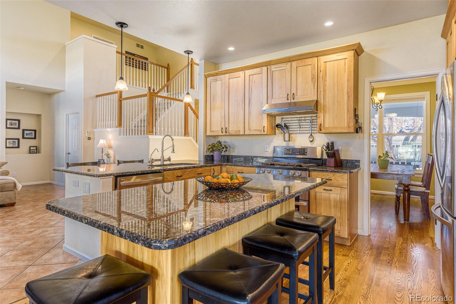 3897 Mallard Lane Highlands Ranch, CO 80126 - Photo 8 of 50 a kitchen with a stove a sink and a refrigerator