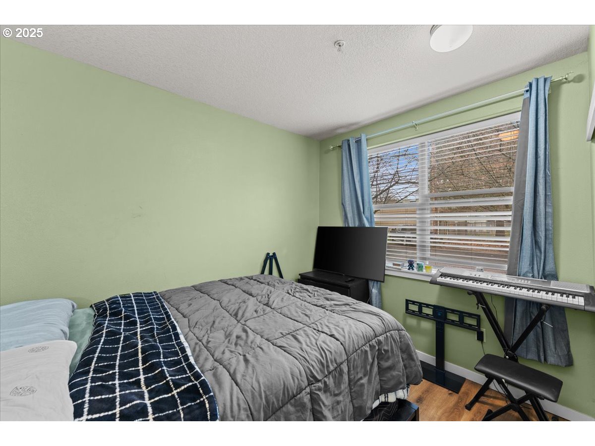 400 Northeast 100th Avenue, Unit 101 Portland, OR 97220 - Photo 20 of 22 a bedroom with a bed and a window